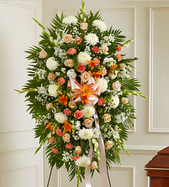 Sympathy standing spray in peach roses