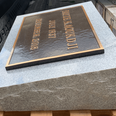 Bronze Plaque on Light grey Granite Pillow