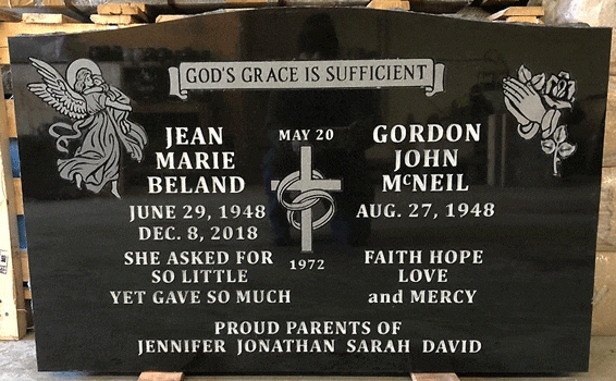Black granite upright headstone with an engraved soaring angel, a ringed cross, and praying hands with a rose