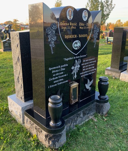 Black granite companion monument with hearts portraits cross and vases