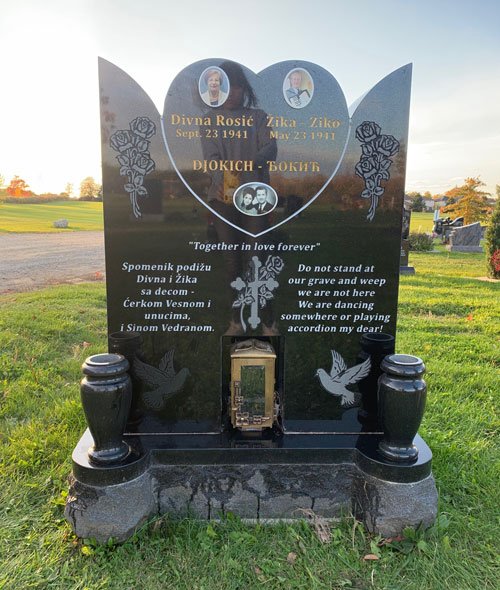 Front view of black granite companion monument with hearts and vases