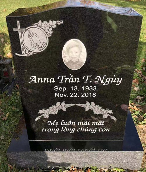 Black granite curved headstone with rose cross and oval portrait