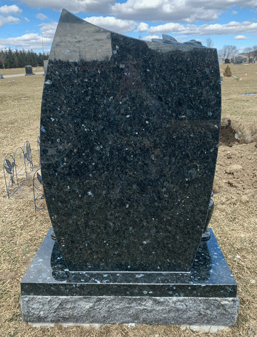 Back view of black granite curved upright headstone