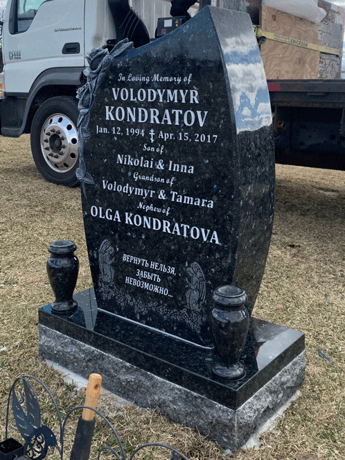 Black granite curved upright headstone with roses and portrait