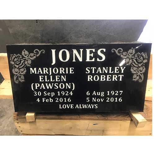 Black granite flat grave marker with carved rose corners