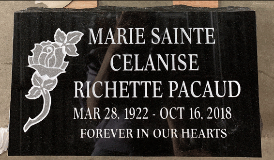 Black granite flat grave marker with a carved rose