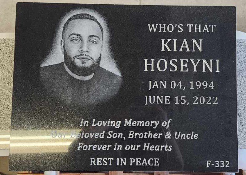 Black granite flat grave marker with a large laser-etched portrait