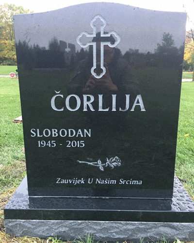 Black granite upright headstone with an engraved Orthodox cross and a single rose