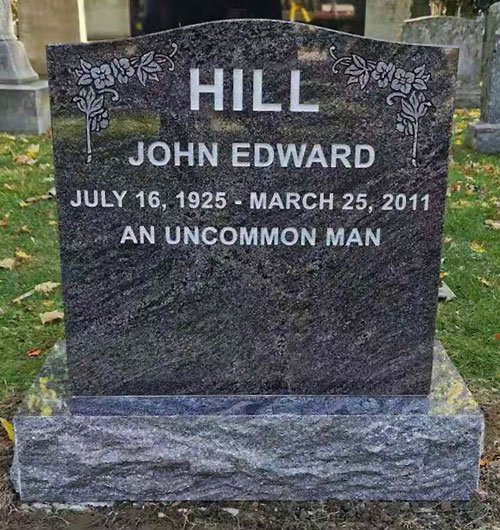 Black granite upright headstone with rose border