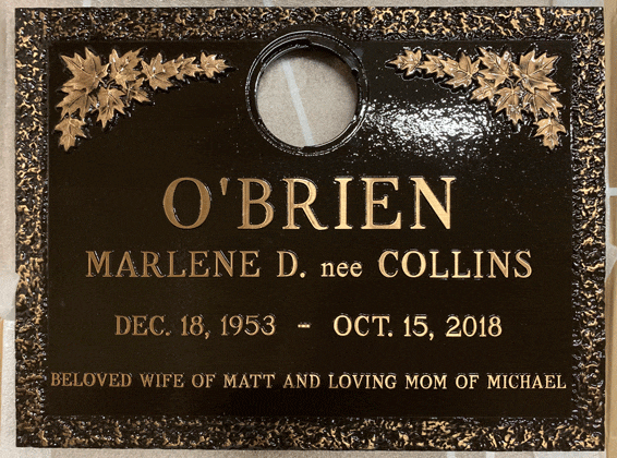 Bronze grave marker with maple leaf border and round vase opening