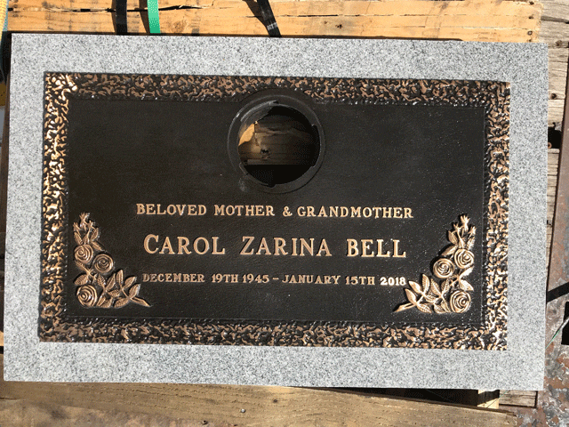Bronze grave marker with rose border and center vase opening