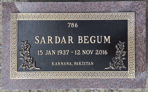 Bronze marker with Greek key border and floral accent