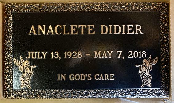 Bronze marker with praying hands and wheat border