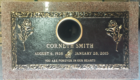 Bronze marker with round portrait medallion and rose corners