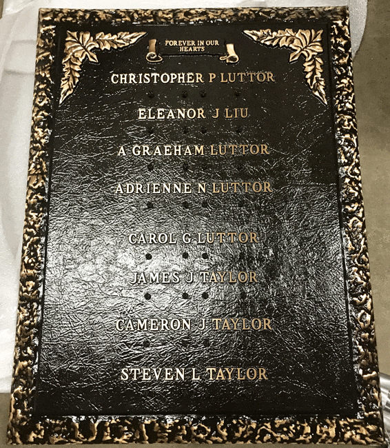 Bronze memorial plaque with ornate floral frame