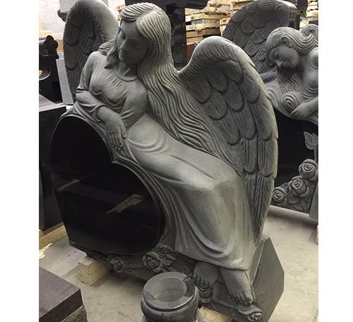 Gray granite angel sculpture headstone with heart