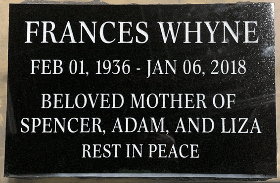 Black granite flat grave marker with engraved inscription