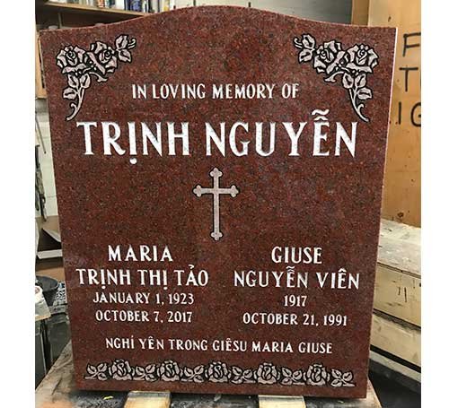 Red granite companion headstone with cross and rose corners