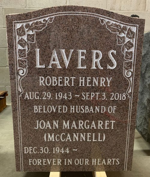 Red granite upright companion headstone with floral corner etching