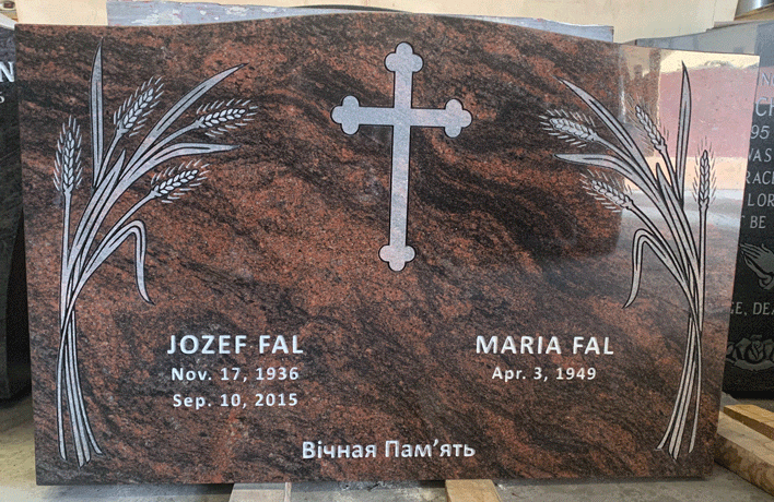 Mahogany granite upright headstone with an engraved cross and wheat sheaves, English and Ukrainian inscription