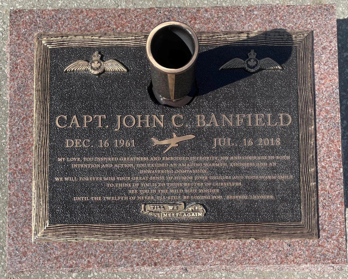 Bronze marker on pink granite base