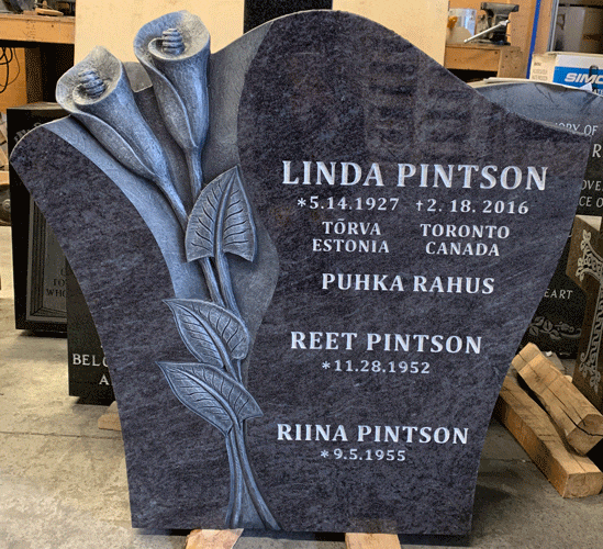 Bahama Blue granite serpentine headstone with carved calla lilies