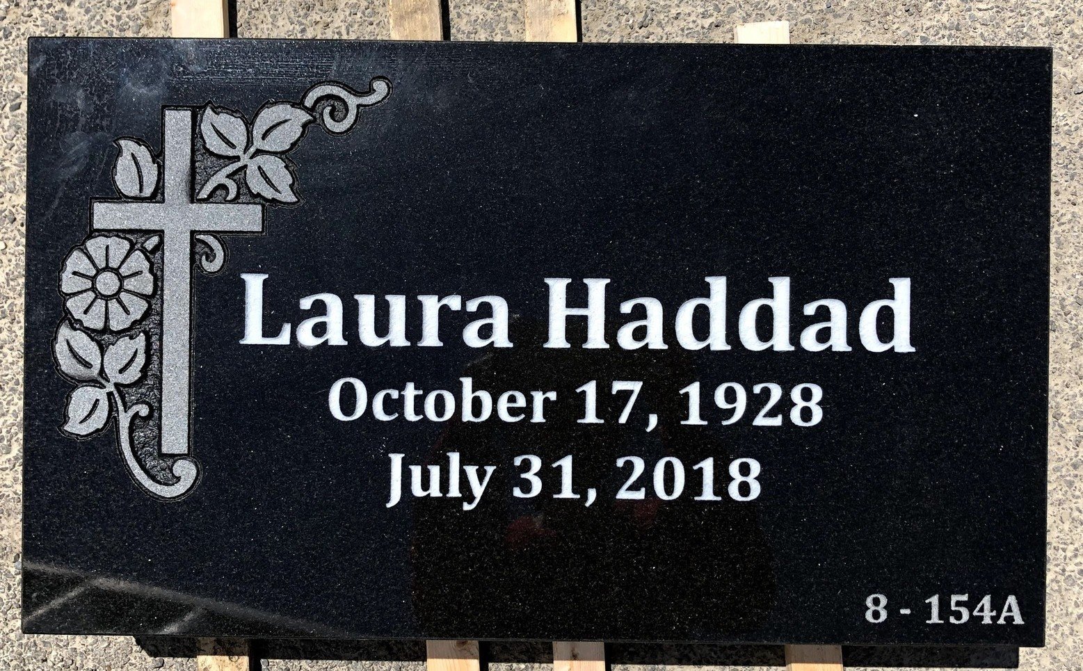 Black flat marker with floral cross artwork