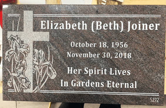Black flat marker with flowers and cross