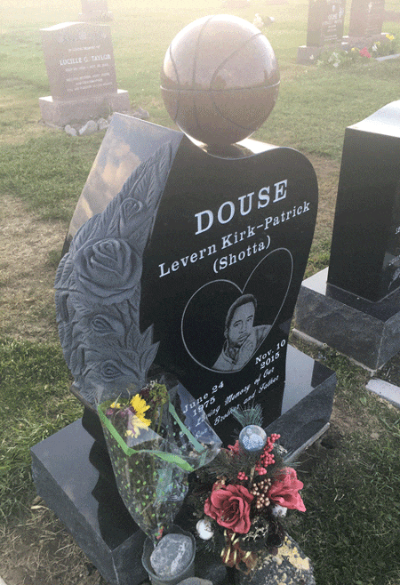 Black granite upright monument with angel wing and round top