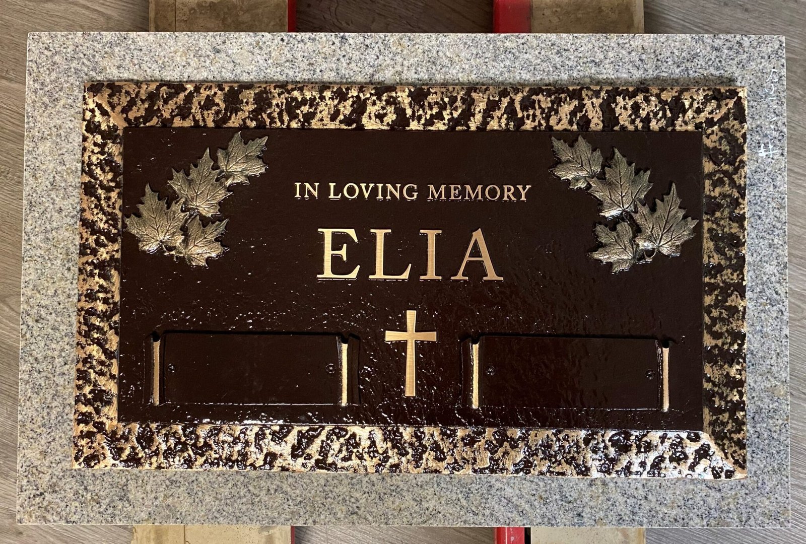 Bronze grave marker with maple leaves and cross