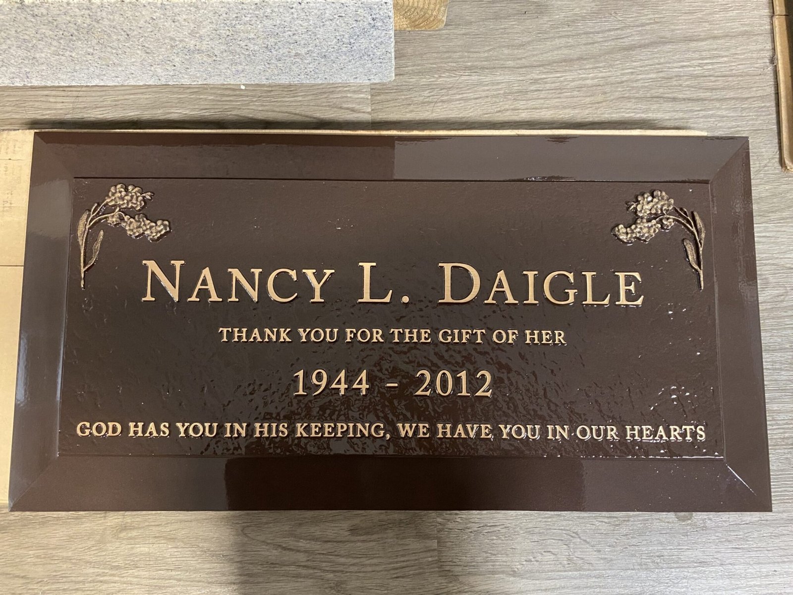 Bronze grave marker with rose corner artwork