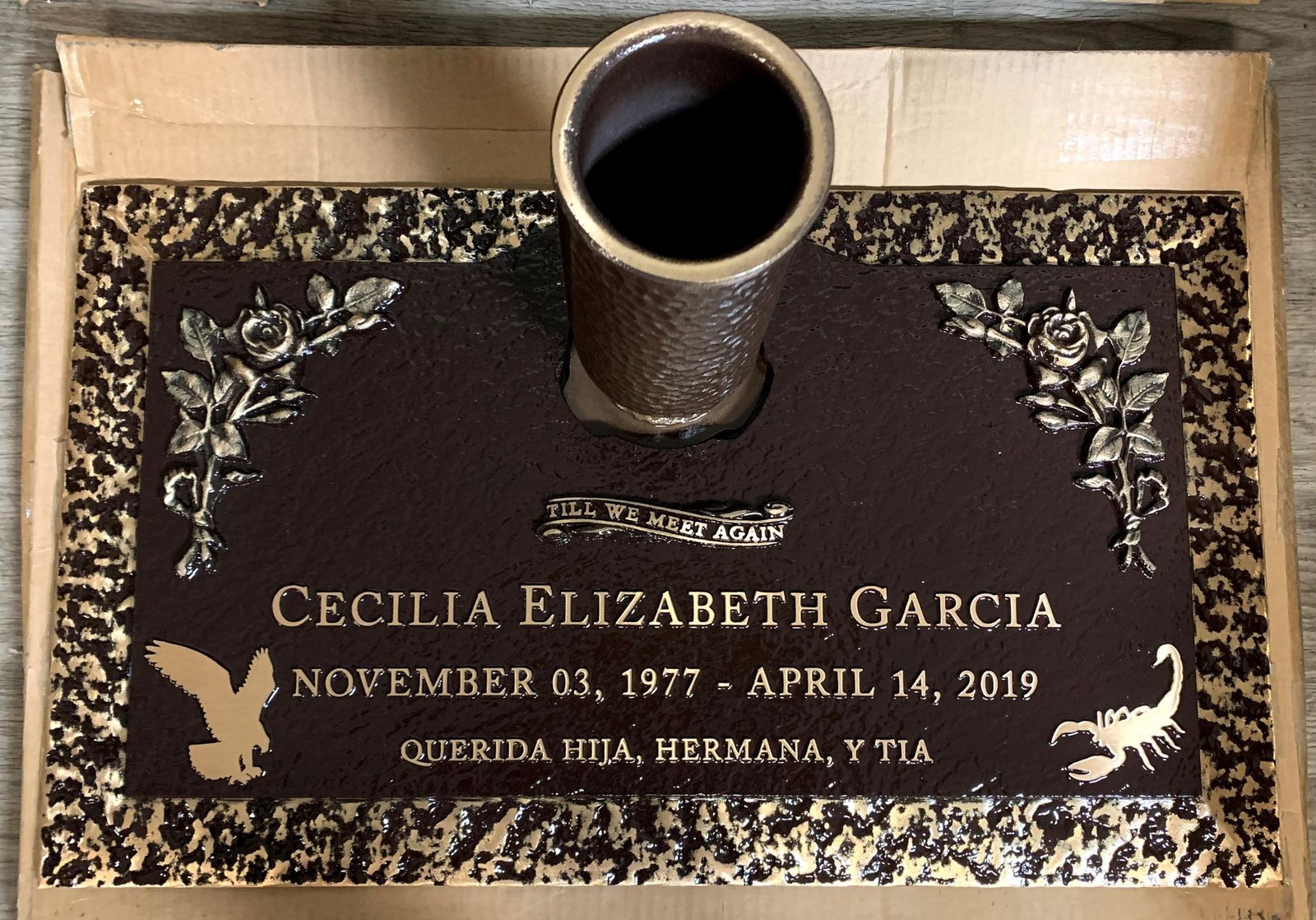Bronze grave marker with vase and floral corner designs