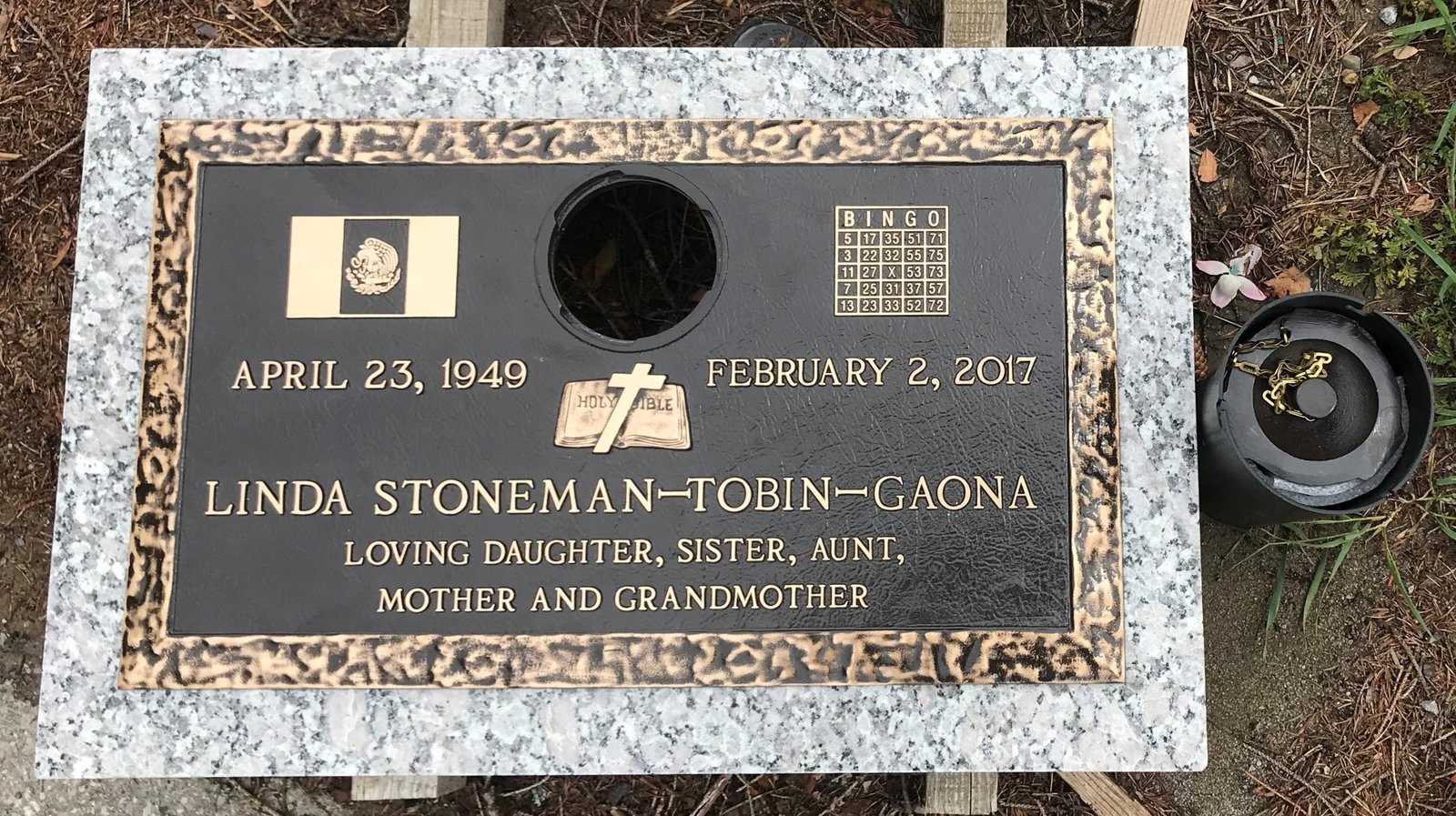 Bronze marker with center vase and memorial emblems