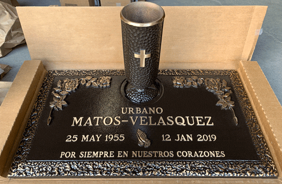 Bronze marker with flower border and vase with cross