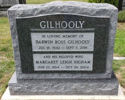 Dark Brits granite serpentine top companion headstone with a rock pitched frame border