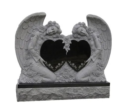 Grey granite double angel monument holding a carved heart