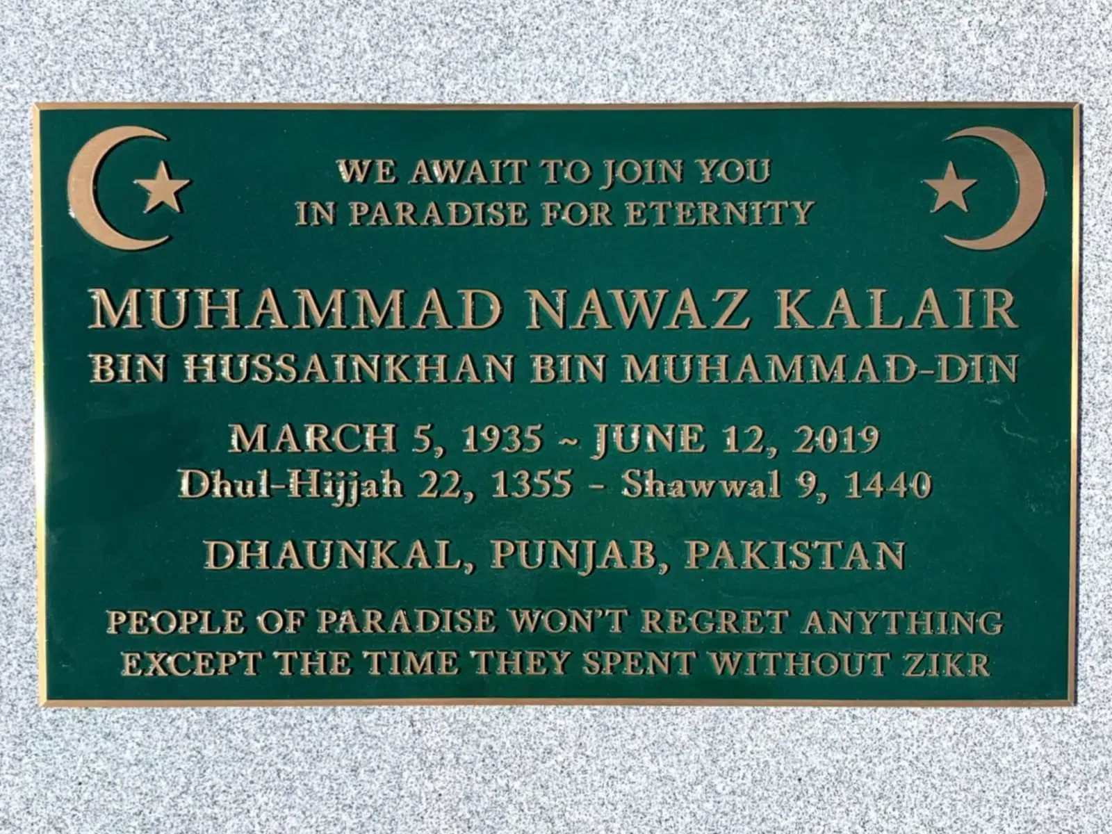 Green bronze grave marker with crescent moon corners and gold inscription