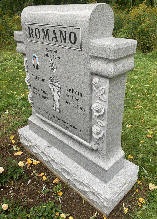 Side view of light gray granite companion headstone with columns