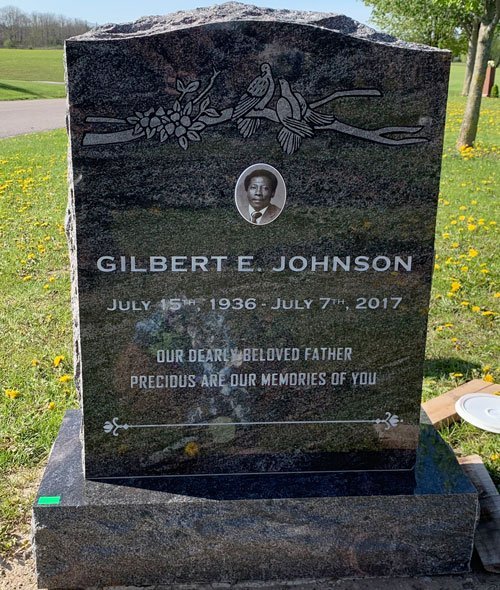 Paradiso granite serpentine top headstone with doves, roses and an etched portrait