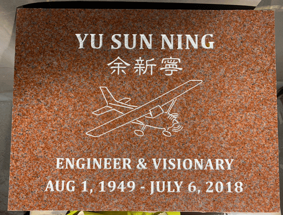 Red granite flat marker with airplane line art