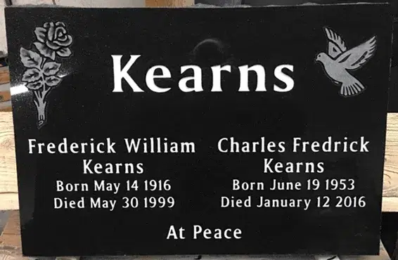 Black granite flat companion grave marker with a carved rose, a dove in flight, a family name and two names with dates