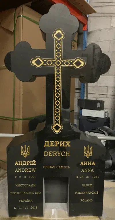 Black granite clover tip cross monument with a gold braided cross, two trident emblems and gold Ukrainian lettering