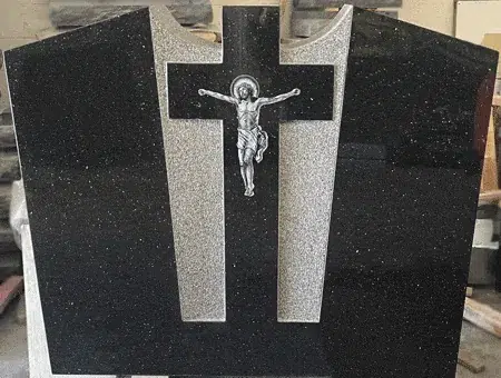 Black granite monument with a frosted cross and a laser etched crucifix on the face