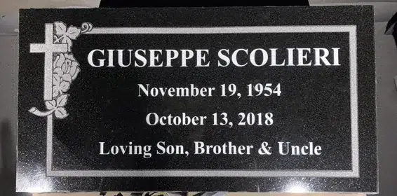 Black granite flat grave marker with a double line border, a cross wrapped in roses, and a name, dates and tribute line