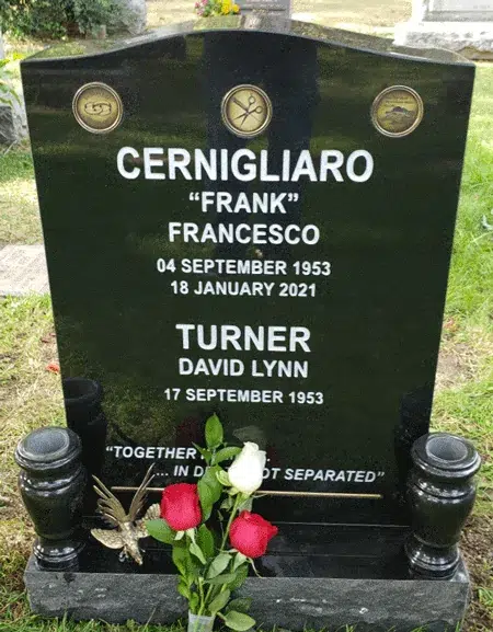 Black Granite Headstone with Bronze Medallions Black granite serpentine headstone with three round bronze medallions, a metal line accent, twin vases and a butterfly