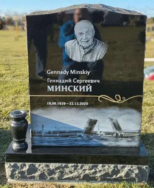 Black granite headstone with laser etched portrait, cityscape and gold ribbon
