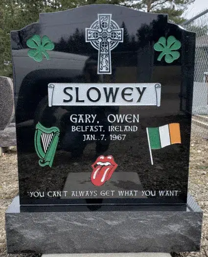 Black granite ogee top headstone with Celtic cross, shamrocks and Irish harp