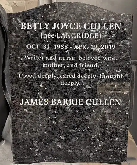 Blue Pearl granite serpentine top headstone with engraved inscription