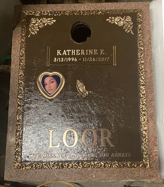 Bronze memorial plaque with a heart shaped photo cameo, praying hands, rose corners, a vase opening and a raised family name