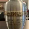 Classic Flower Metal Urn MU225, brushed pewter finish with a gold flower band, engraved with a name, dates and epitaph